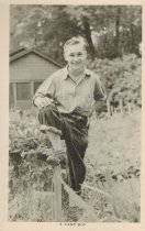 Arden Shore boy near a fence